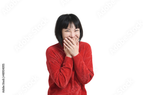Fényképezés Young asian woman laughing and embarrassed giggle covering mouth with hands, wearing winter red sweater isolated on white background