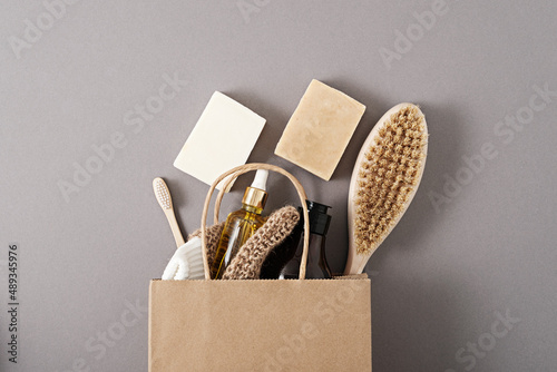 top view eco organic natural cosmetic products in craft package on grey background photo