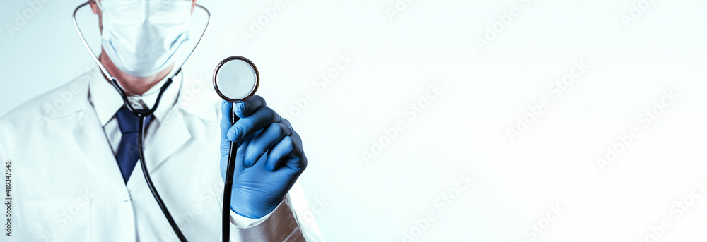 Stethoscope doctor medical background. Happy nurse in hospital uniform, blue gloves holding stethoscope isolated on white. Medicine service and healthcare concept. Stethoscope doctor medical background. Happy nurse in hospital uniform, blue gloves holding stethoscope isolated on white. Medicine service and healthcare concept.