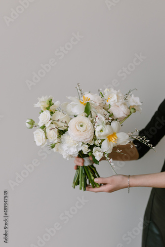 Beautiful bouquet in female hands. The florist is holding flowers.