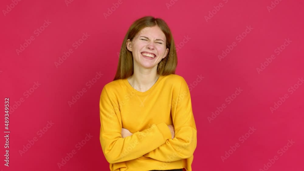 Young woman keeping the arms crossed while smiling over isolated background Young woman keeping the arms crossed while smiling over isolated background