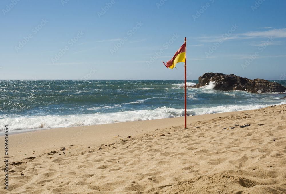 The yellow-red flag on the beach - Portugal The yellow-red flag on the beach - Portugal