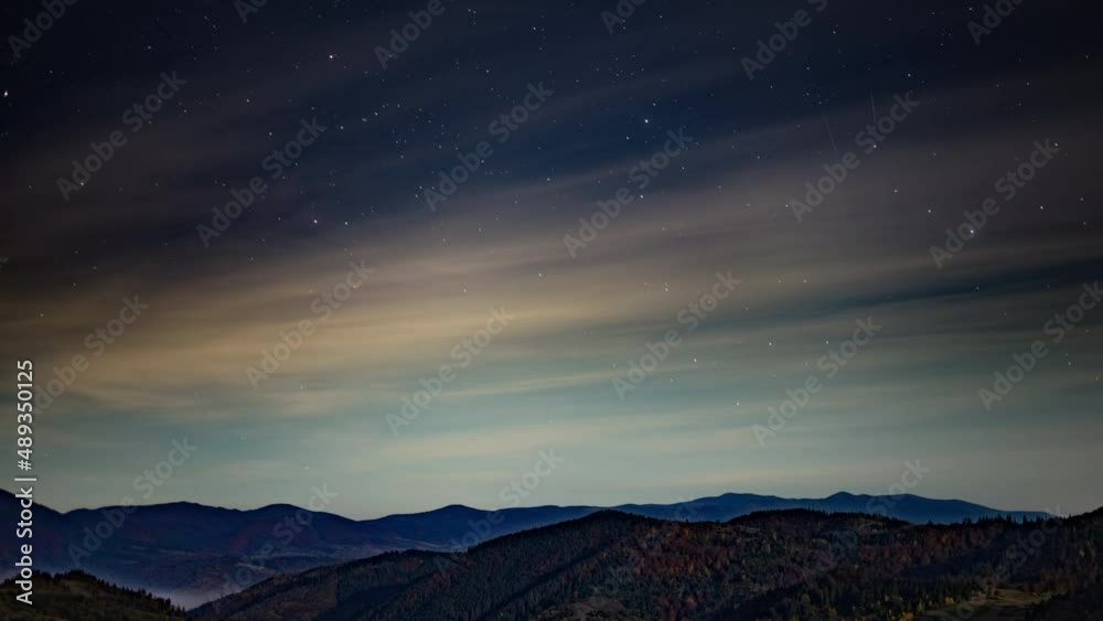 Night starry sky with light pink clouds floating at twilight Night starry sky with light pink clouds floating at twilight