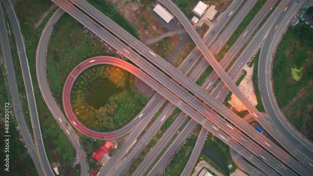 4K : Hyperlapse or Dronelapse Top view of Highway road junctions. The Intersection freeway road overpass the eastern outer ring road. Time lapse Aerial view 
