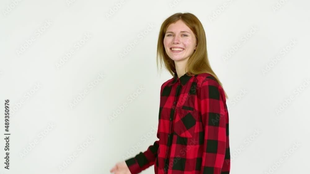 Young woman pointing back and presenting a product over isolated background Young woman pointing back and presenting a product over isolated background