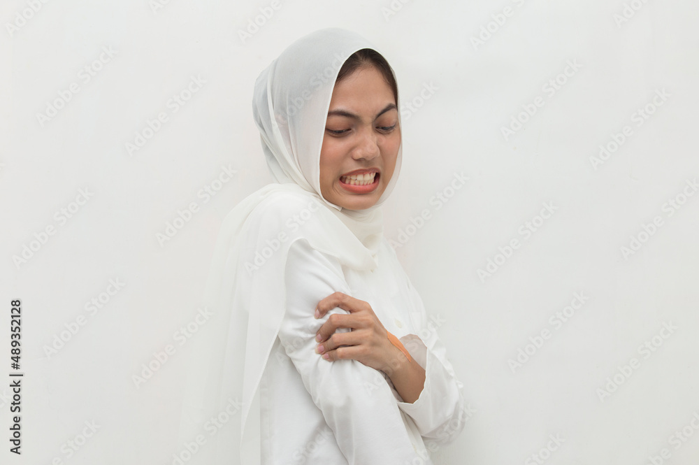 muslim woman having pain in injured elbow hand isolated on white background muslim woman having pain in injured elbow hand isolated on white background
