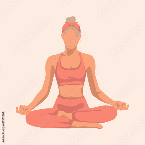 blonde woman doing yoga sitting in a lotus position in a red suit