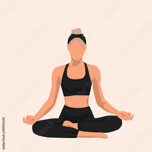 blonde woman doing yoga sitting in lotus position in black suit
