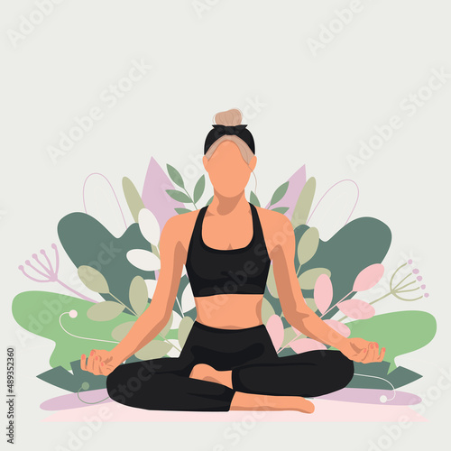 a blonde girl doing yoga sits in a lotus position in a black suit against the background of plants