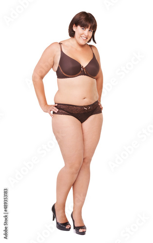 Curvaceous and proud of it. Full length portrait of a voluptuous woman in lingerie on a white background.