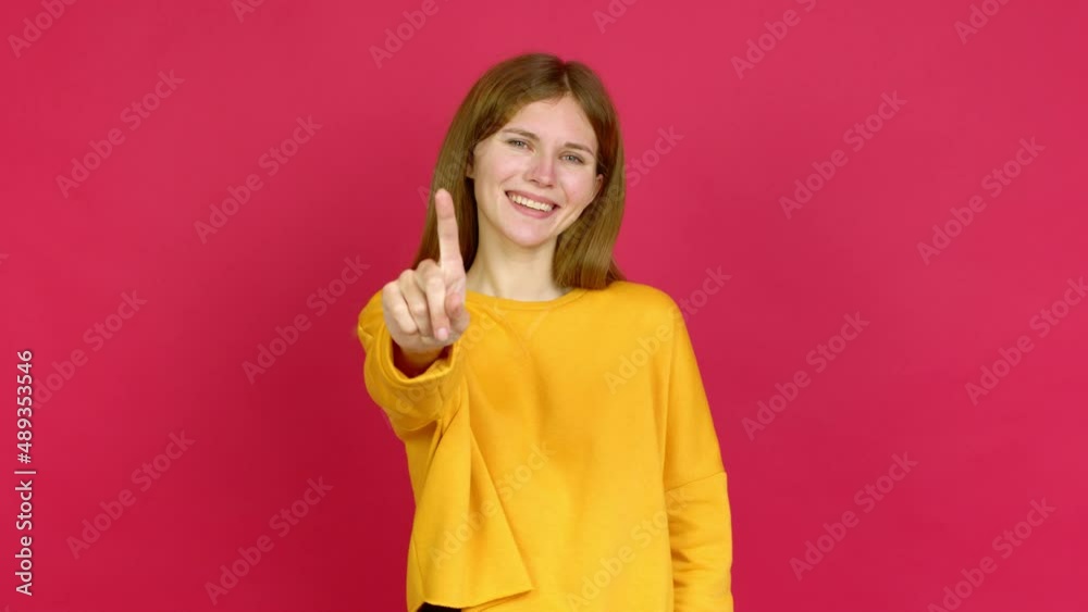 Young woman showing and lifting a finger in sign of the best over isolated background Young woman showing and lifting a finger in sign of the best over isolated background