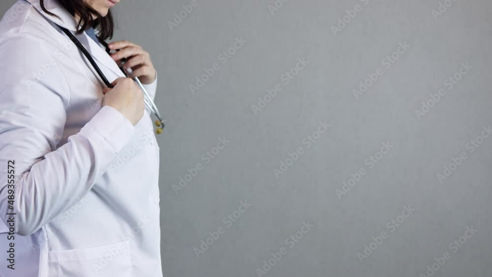 unrecognizable female doctor in white uniform lab coat putting ...