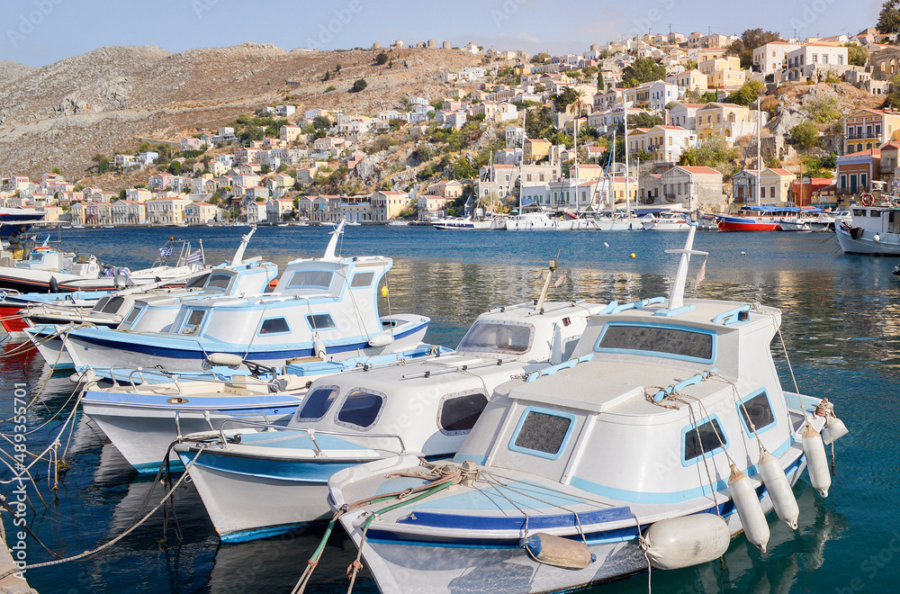 A row of boats tied to the waterfront on the Greek island of Symi.