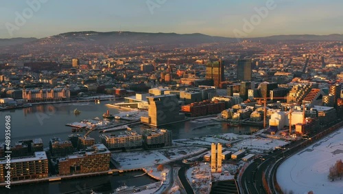 Oslo, Norway. Aerial view of Sentrum area of Oslo, Norway, with modern and historical buildings and car traffic. Grey sky in winter with snow, flying over Oslo photo