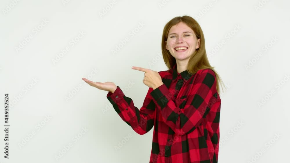 Young woman holding something over isolated background Young woman holding something over isolated background