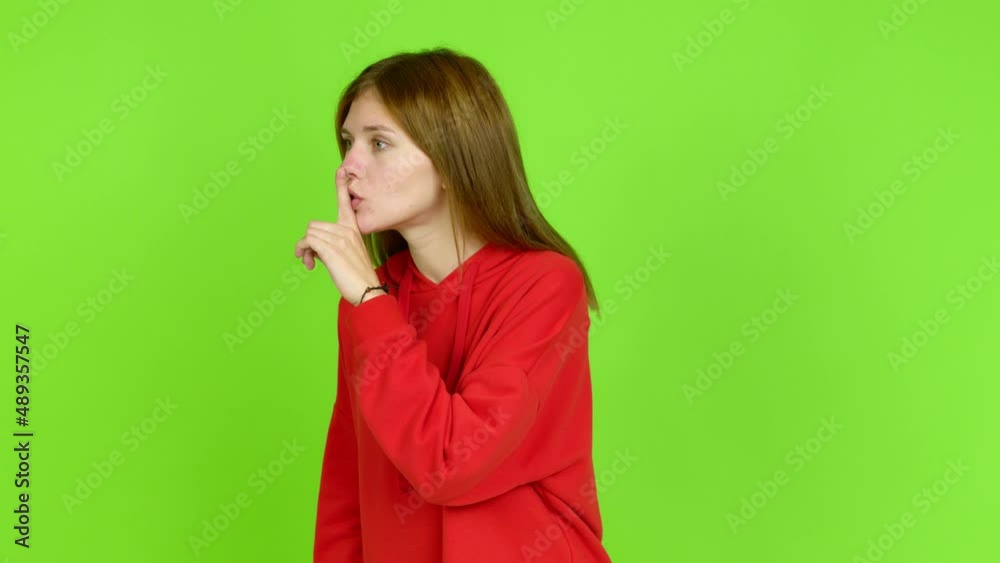 Young woman doing silence gesture over isolated background. Green screen chroma key Young woman doing silence gesture over isolated background. Green screen chroma key