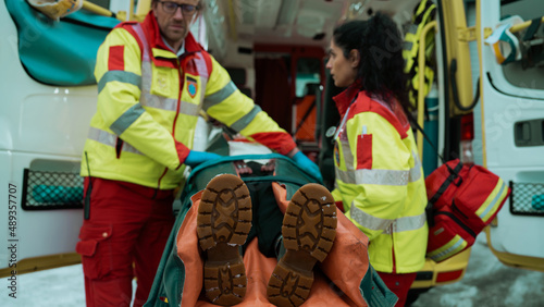 Quadro su tela Emergency Care Workers Pushing a Stretcher Into The Ambulance Car After Saving a Female From a Horrible Car Accident, Her Laying on The Stretcher Unconscious