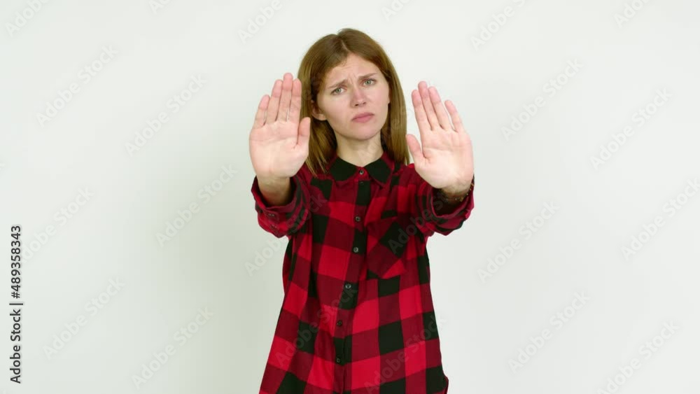 Young woman doing stop sign over isolated background Young woman doing stop sign over isolated background