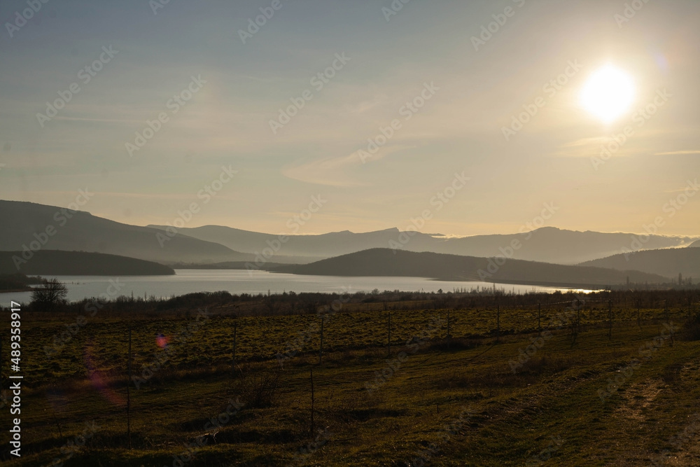 THE SUN SETS BEYOND THE MOUNTAINS THE SUN SETS BEYOND THE MOUNTAINS