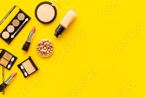 Decorative makeup cosmetic on color background, top view