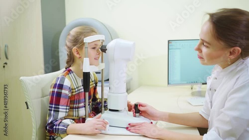 ophthalmologist examines the girl on a corneo topographer. modern clinic. photo