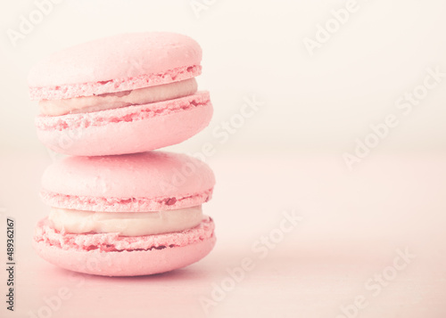 Pink macarons close-up. Horizontal photo. Delicious macaroons. Stack of two macarons.
