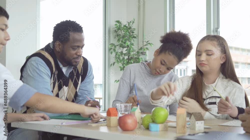 A group of multi ethnic of students kids and teachers study, learn art painting, drawing in school. Education in classroom. People lifestyle A group of multi ethnic of students kids and teachers study, learn art painting, drawing in school. Education in classroom. People lifestyle
