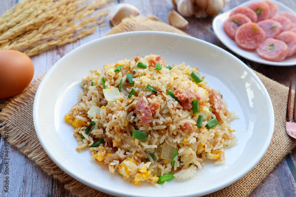 Fried rice with fermented pork and vegetables - In Thai food called Khao Pad Naem at close up view on wood table Fried rice with fermented pork and vegetables - In Thai food called Khao Pad Naem at close up view on wood table