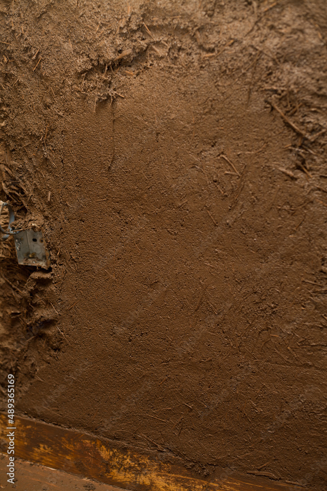 Fototapeta premium Building a House with Straw Clay - mixing ingredients on the building site. Ancient techniques of traditional architecture.