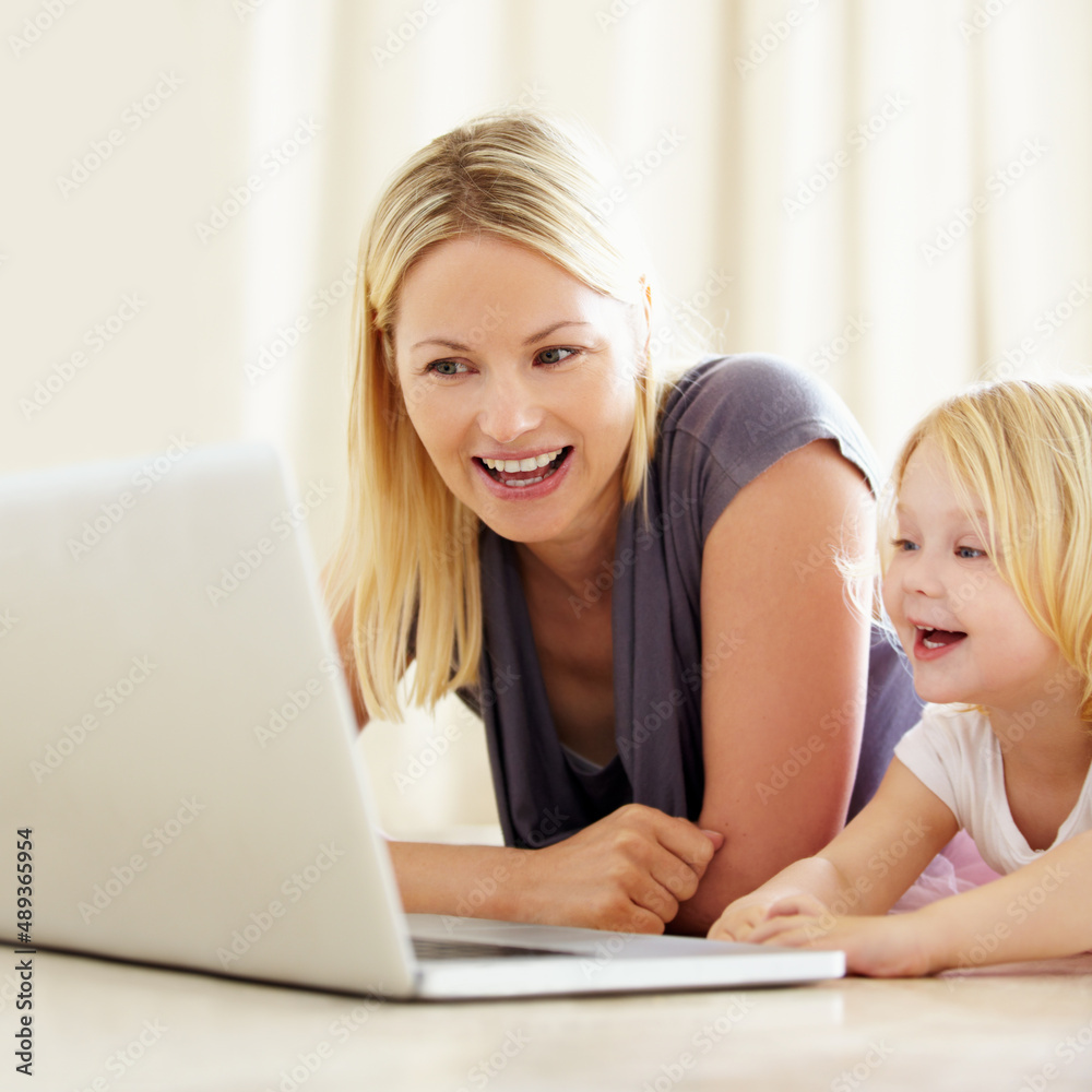 She loves watching cartoons online. Shot of a mother and daughter bonding while surfing the internet together. She loves watching cartoons online. Shot of a mother and daughter bonding while surfing the internet together.