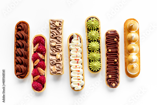 Fotomurale Top view of sweet bakery eclairs with color topping