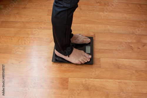 Male on weight scale on floor background, Diet concept.