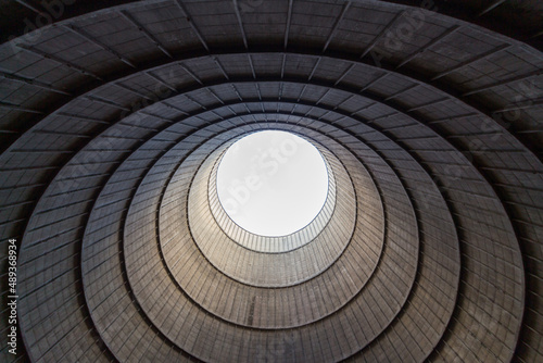 Inside a cooling tower of a nuclear power plant. View upwards, sky with haze
