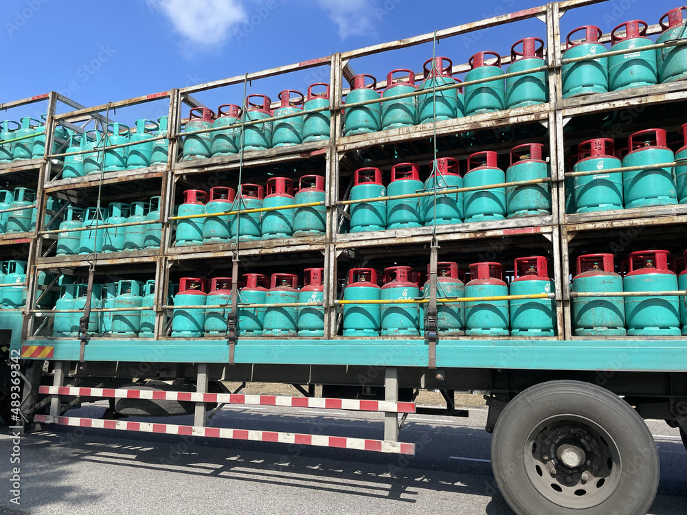A photo of a truck loaded with gas steel containers in Paka, oil and gas processing station - obrazy, fototapety, plakaty 