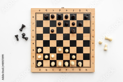 Top view of chess pieces battle on chessboard. Teamwork concept
