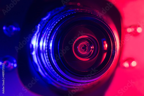 Camera lens with purple and red backlight. Optics. Cyberpunk style