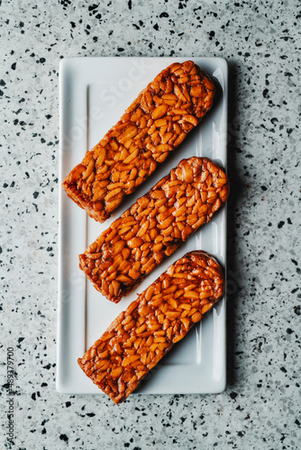 Tableau sur toile blocks of marinated tempeh in a white plate