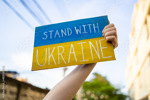 Fototapeta Demonstrator holding Stand with Ukraine placard