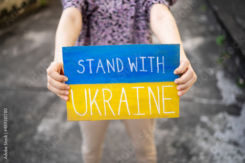 Fototapeta Demonstrator holding Stand with Ukraine placard