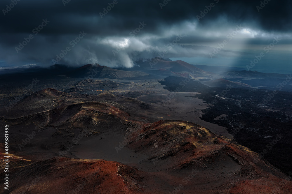 Black lava fields near Tolbachik volcano in Kamchatka peninsula, Russia. Summer landscape with stormy sky.	