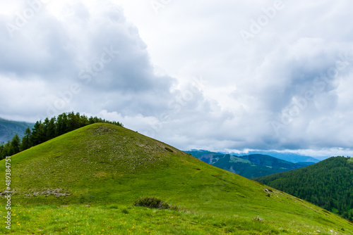 A picturesque landscape view of the French Alps mountains on a cloudy summer day (Valberg, Alpes-Maritimes, France)