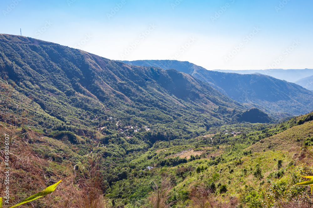 mountain range covered with dense green forests and bright blue sky at morning mountain range covered with dense green forests and bright blue sky at morning