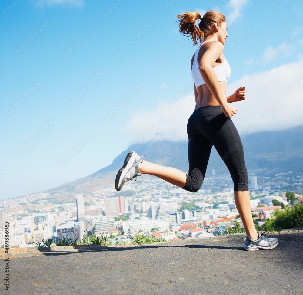 Cross country. Shot of a sporty young woman going for a run outdoors. Cross country. Shot of a sporty young woman going for a run outdoors.