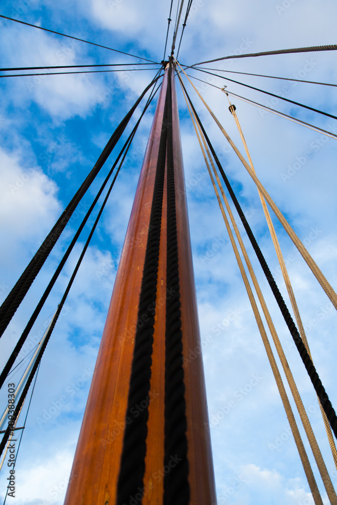 Fototapeta premium Mast of a sailing yacht without a sail. View from below.