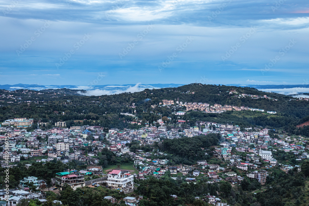 downtown city view with dramatic cloudy sky at evening from mountain top