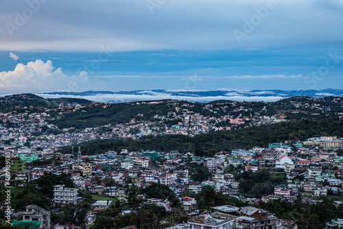 downtown city view with dramatic cloudy sky at evening from mountain top