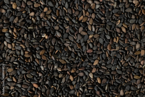 A lot of black sesame seeds, top view, dark brown dry small seeds, heap