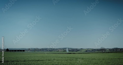 Windskating across fields. Surfing sail in the sun along a road.