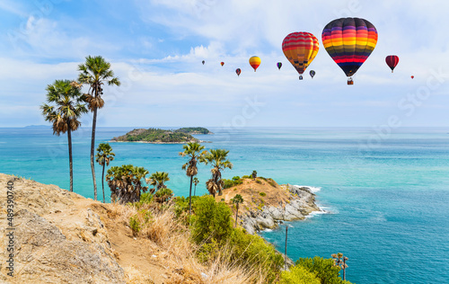 Colorful hot air balloons flying over Phromthep cape, one of the most photographed locations in Phuket, Thailand