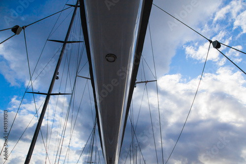 Mast of sailing yachts with ropes for fastening, closeup.